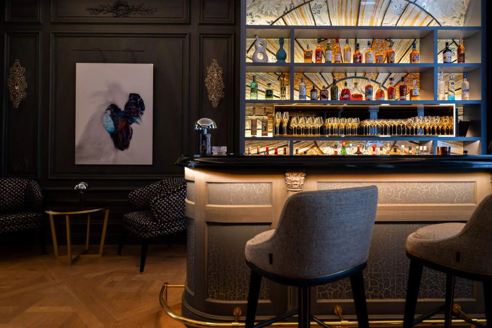 The bar and its backlit wall of bottles — Maison Bauchart