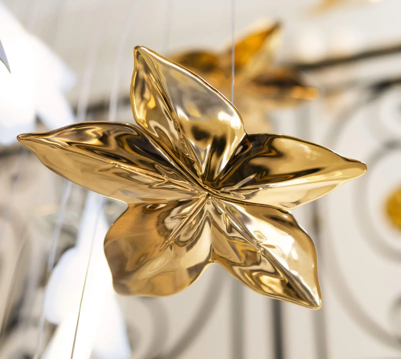 Gilded sculpture by the staircase — Maison Bauchart