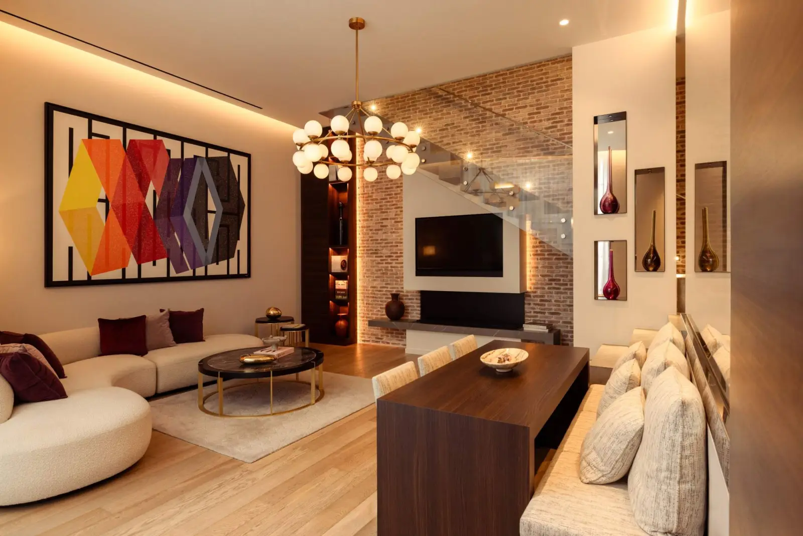 Bauchart Duplex Loft, the living room, curved sofa and brick wall — Maison Bauchart, Paris 8th