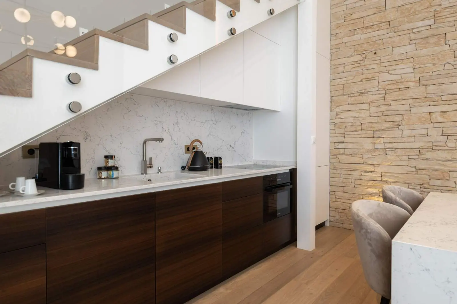 Chaillot Duplex Loft, the kitchen beneath the stairs — Maison Bauchart, Paris 8th