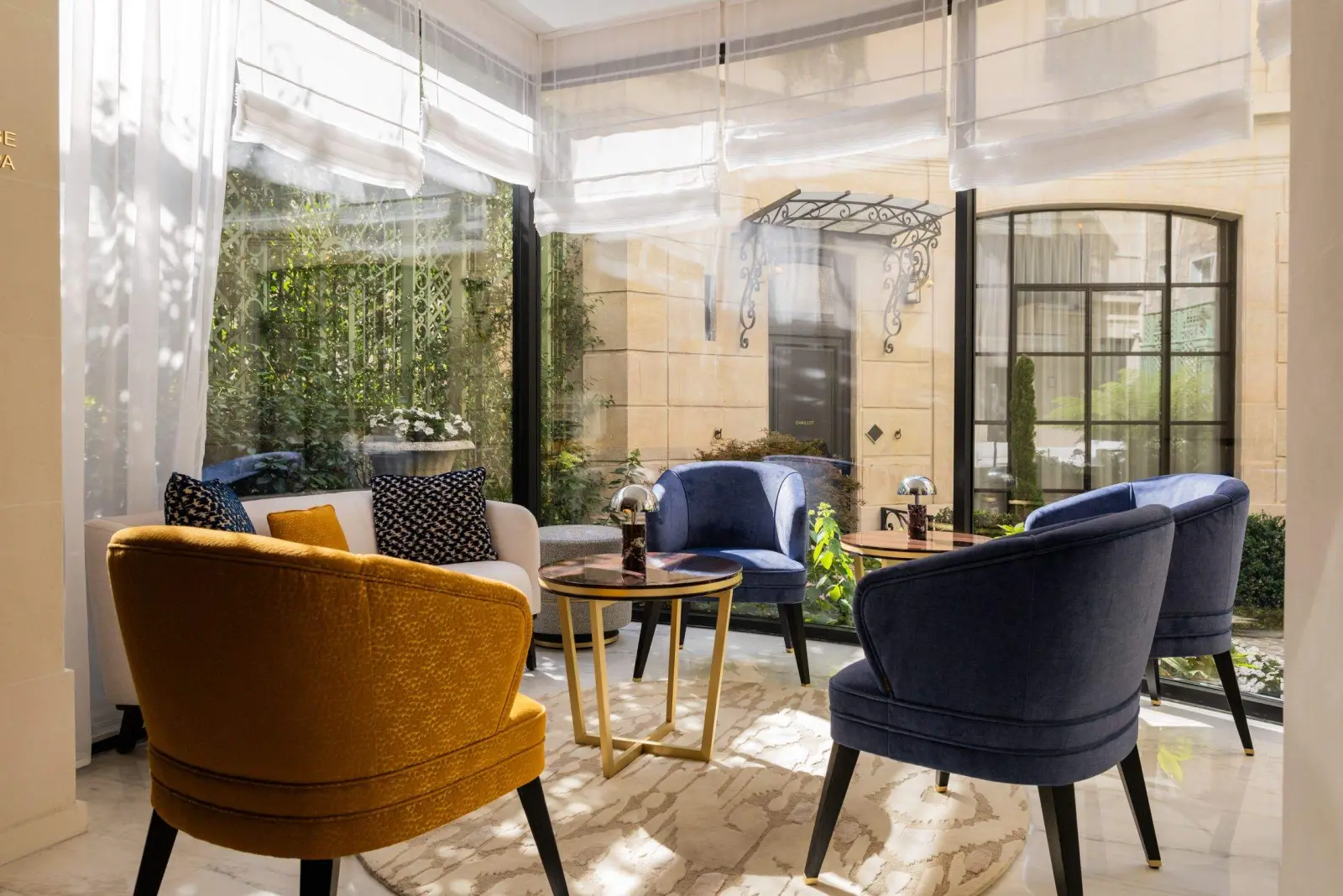 The winter garden beneath its glass roof, open to the courtyard — Maison Bauchart