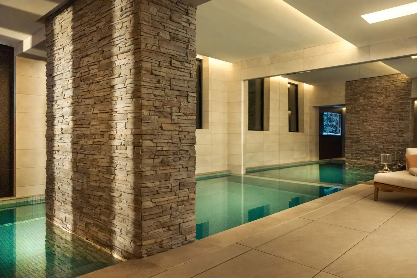 Indoor pool between stone pillars — Maison Bauchart spa