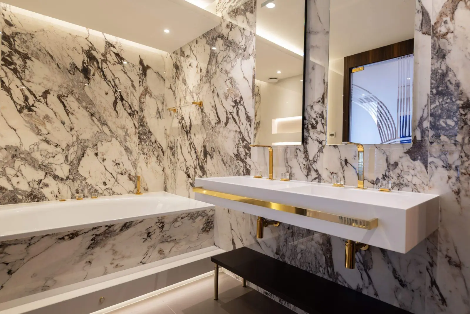 Montaigne Suite, the veined-marble bathroom — Maison Bauchart, Paris 8th