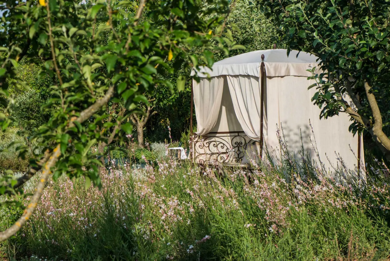 A daybed in the wild gardens — Borgo Santo Pietro