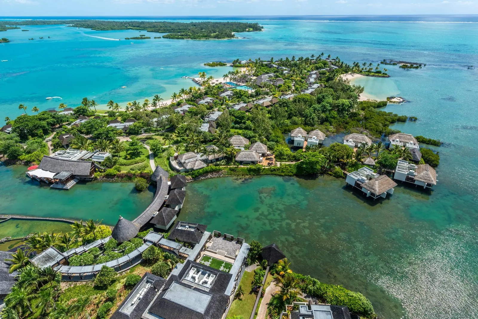 Aerial view of Four Seasons Resort Mauritius at Anahita — thatched villas on the lagoon, Île aux Cerfs beyond