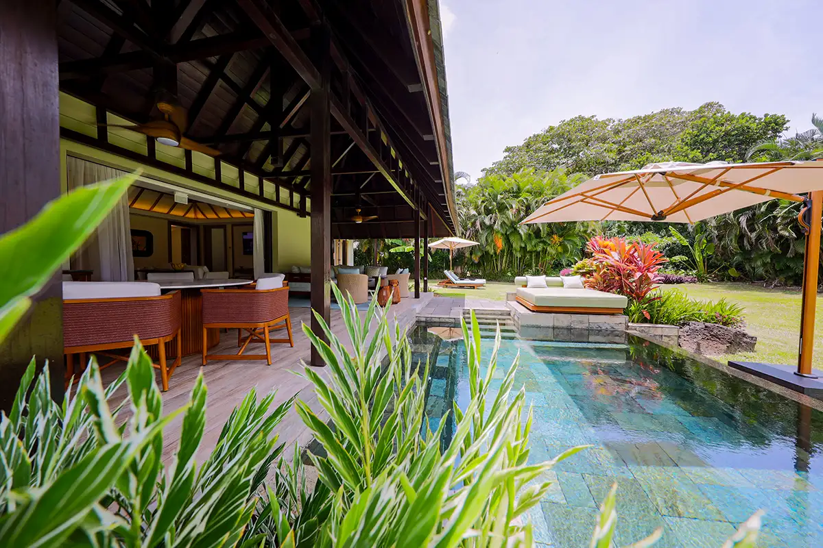 Terrace, pool and tropical garden of a renovated Four Seasons villa at Anahita