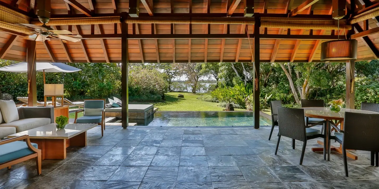 Covered veranda of a Four Seasons villa opening onto the pool and the lagoon