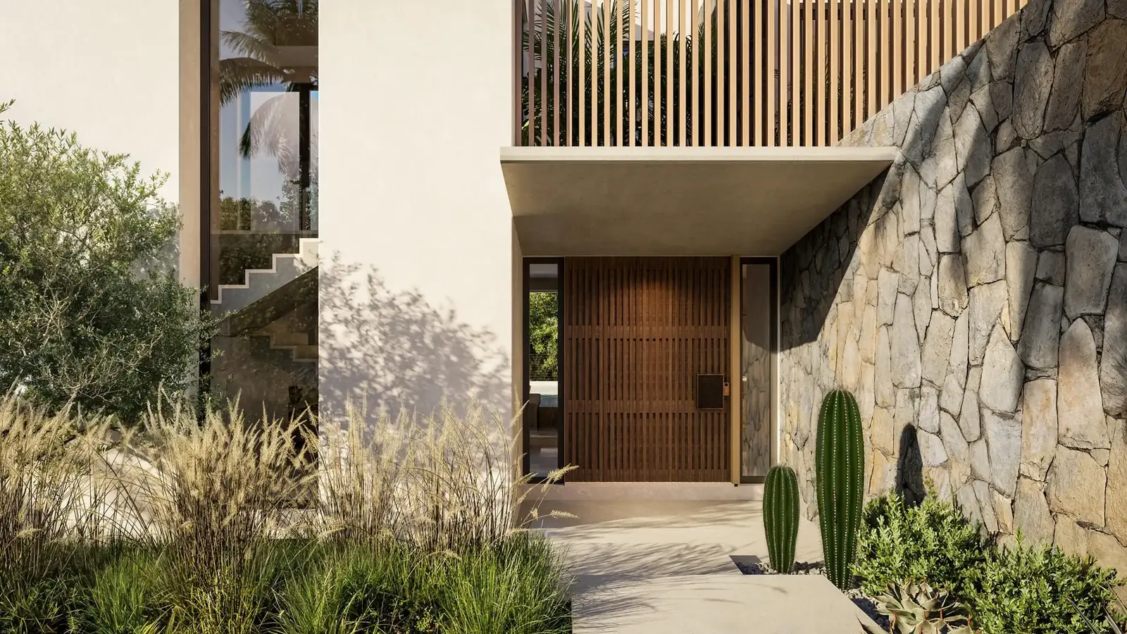 Entrance to a Valriche by YOO villa — stone wall and timber door
