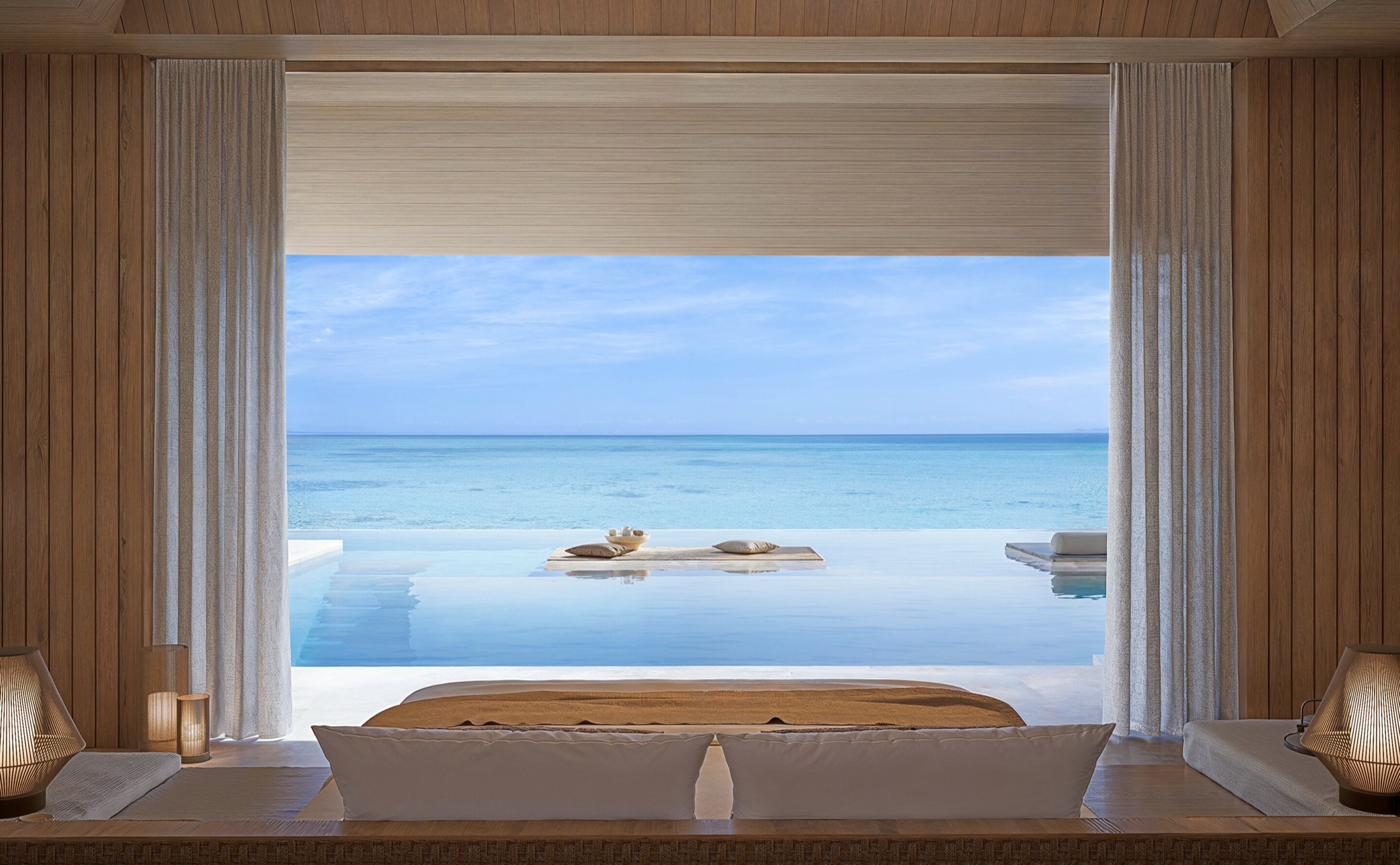 Aman Residences Maldives — private beach pavilion framing an infinity pool and the Indian Ocean, Vaavu Atoll